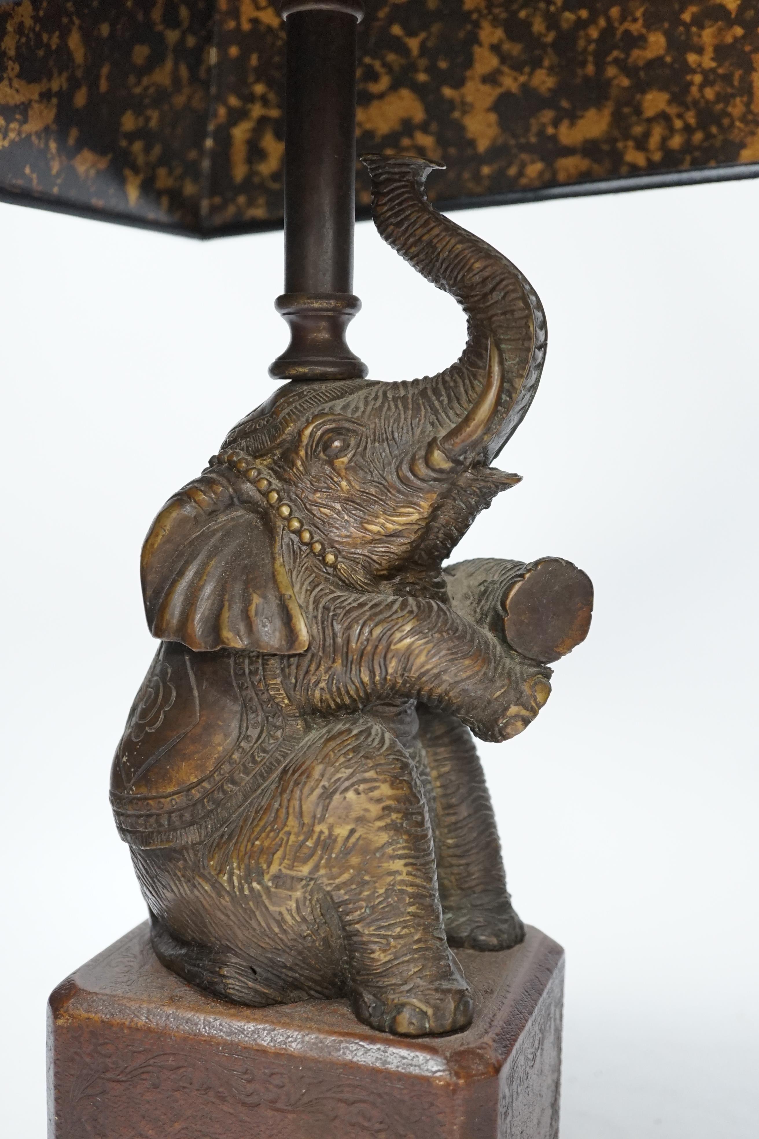 A bronzed elephant table lamp with chinoiserie shade, 65cm high
